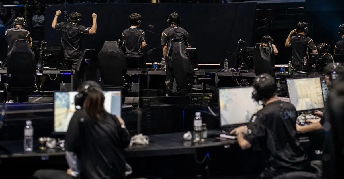 Anonymous esports players react after a close match in a crowded arena