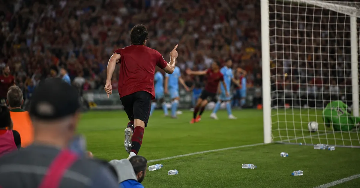 Anonymous forward celebrates a goal during a tense football match.