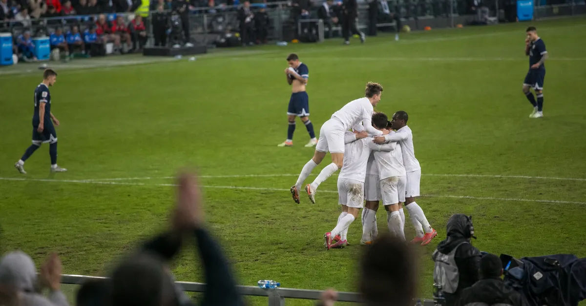 Anonymous footballers celebrate a late equalizer as opponents walk away.