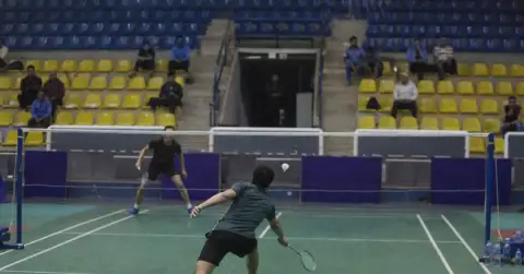 Anonymous badminton players compete during an indoor tournament in Cairo.