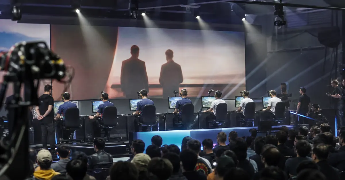 Eight anonymous esports players compete at gaming stations onstage.