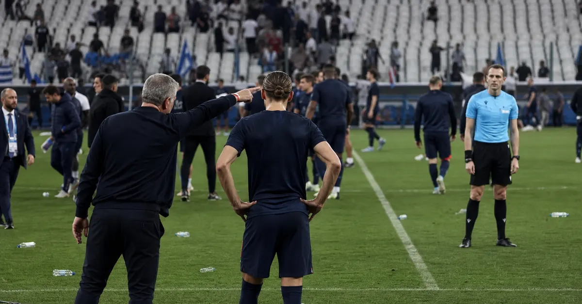 Coach and forward speak with a referee near the touchline