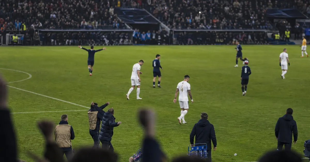 Anonymous footballers react to a late goal in an international match