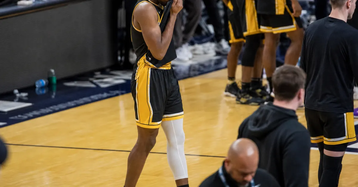 Anonymous basketball player wipes tears after an emotional opening-game victory.