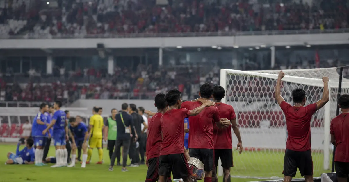 Anonymous Indonesian players celebrate their tournament victory after a penalty shootout.