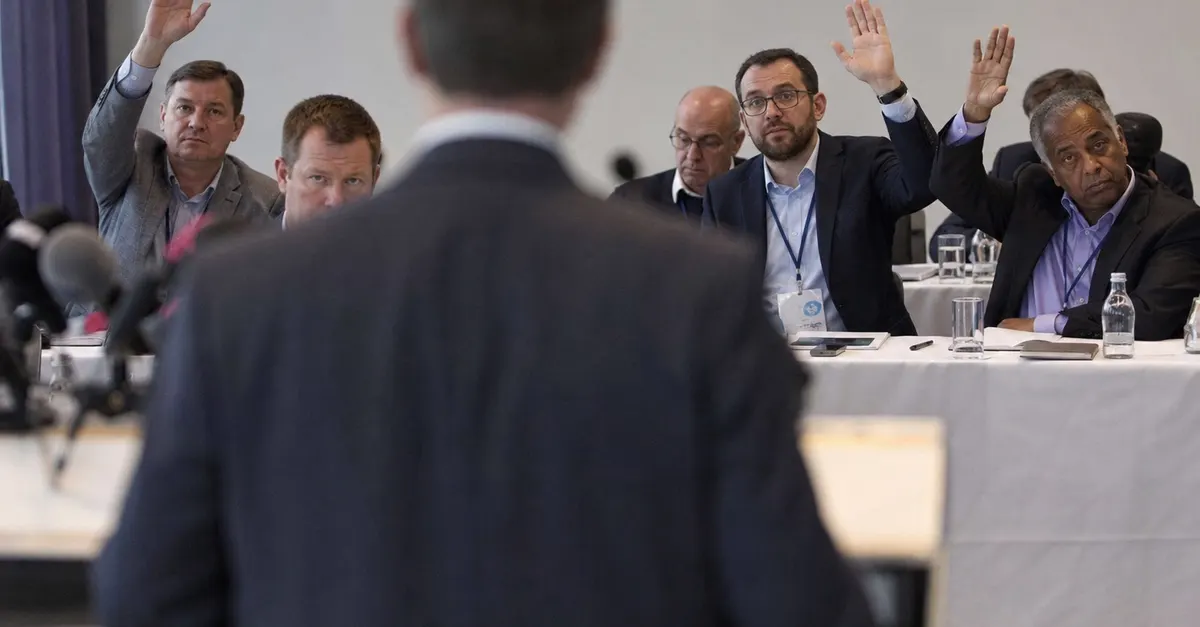 Anonymous football official addresses delegates in a plain press conference room