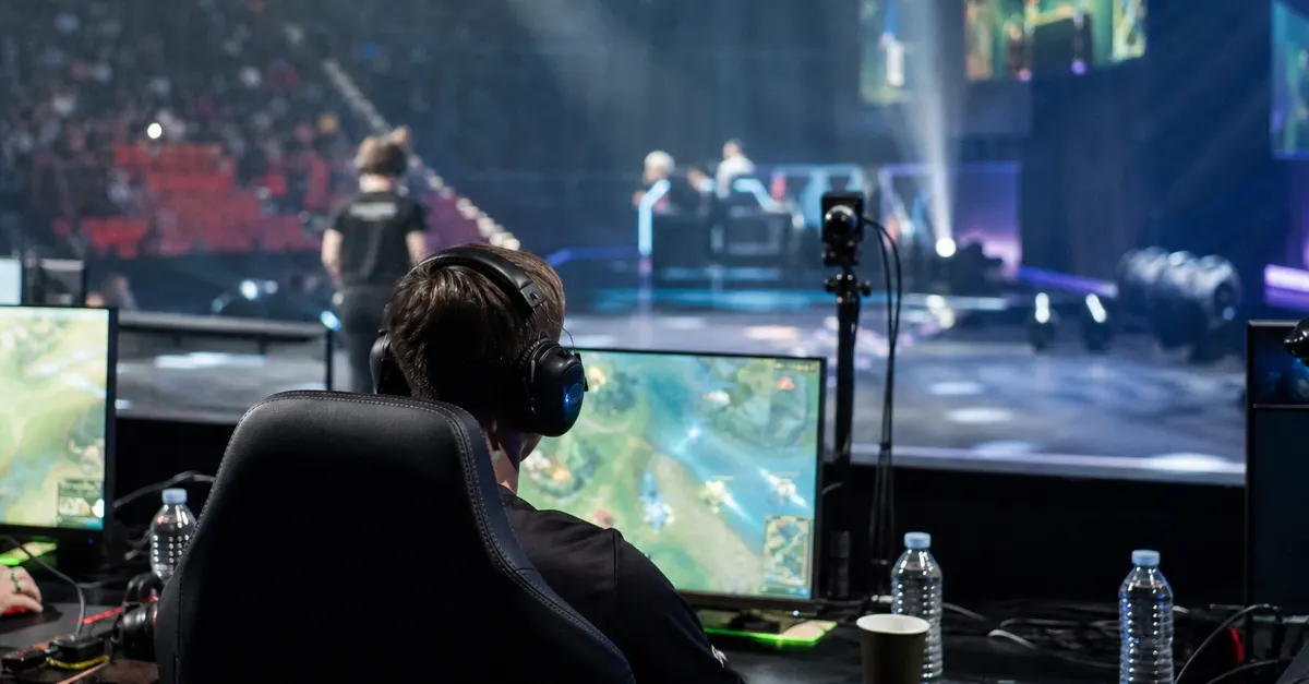 Anonymous esports player competes at a gaming station in a tournament arena