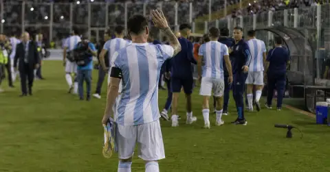 Anonymous footballer waves to supporters after an emotional international farewell.