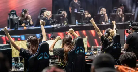 Anonymous esports players compete at PCs during a women’s tournament playoff.