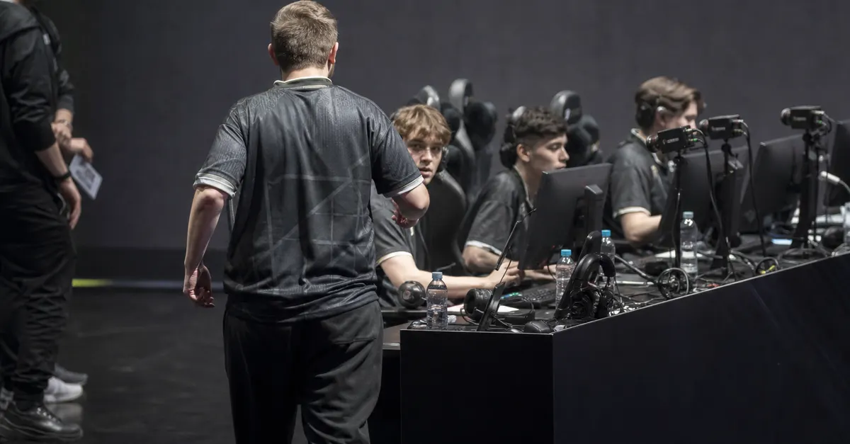 Experienced esports player rejoins younger teammates at a row of gaming PCs