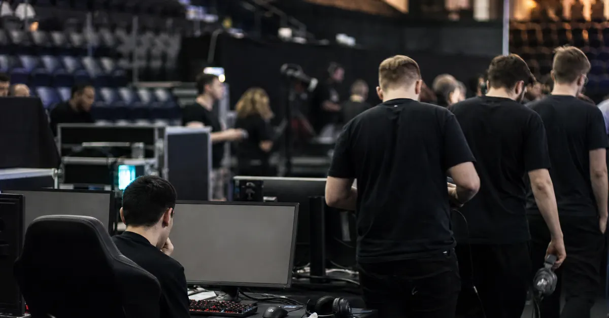 Esports competitors pack away headsets after a team misses qualification.