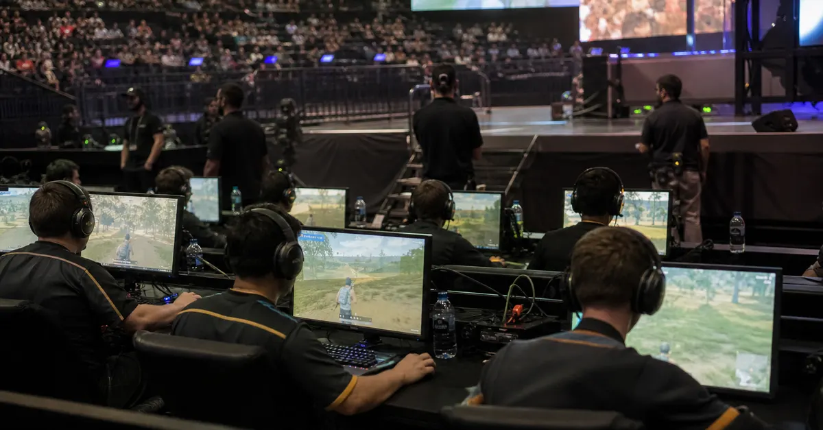 Anonymous esports players compete at PCs in a tournament arena