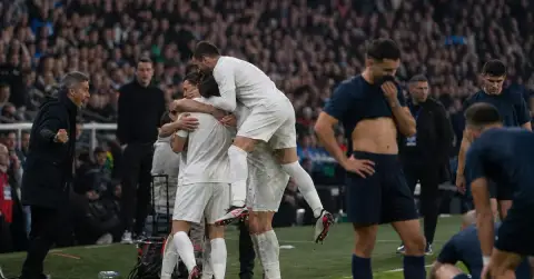 Anonymous footballers celebrate while their opponents regroup after a tense match.