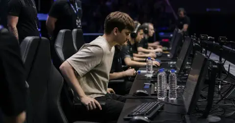 Anonymous esports player joins teammates at a gaming arena setup