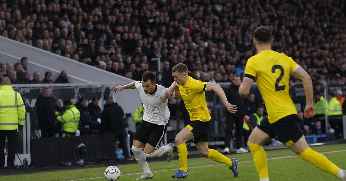 Anonymous footballers contest the ball during a tense league match.